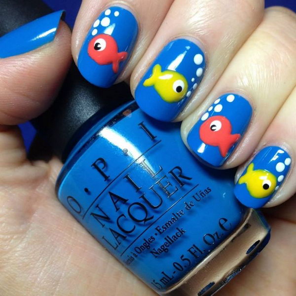 Beach Nail Design with  Colorful Fishes. I love these cute and colorful fishes on blue base nails. This nail design is perfect for a beach party or some water related activity. 