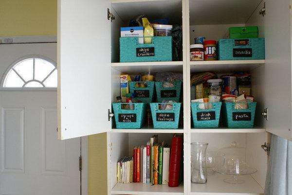 Use baskets with wooden chalkboard labels to organize your pantry cabinet 