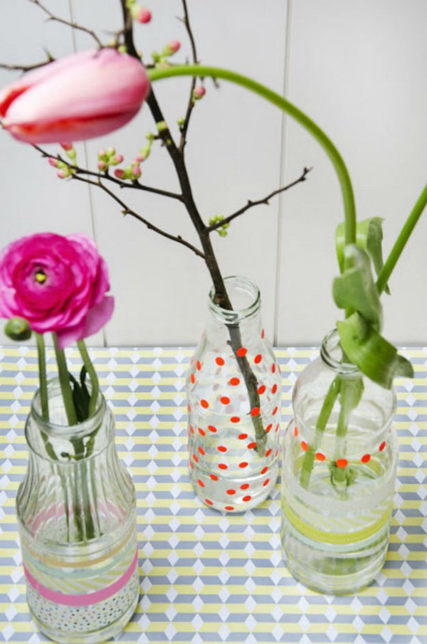 Create a DIY flower vase with old juice bottles, colourful flowers and fancy tape 