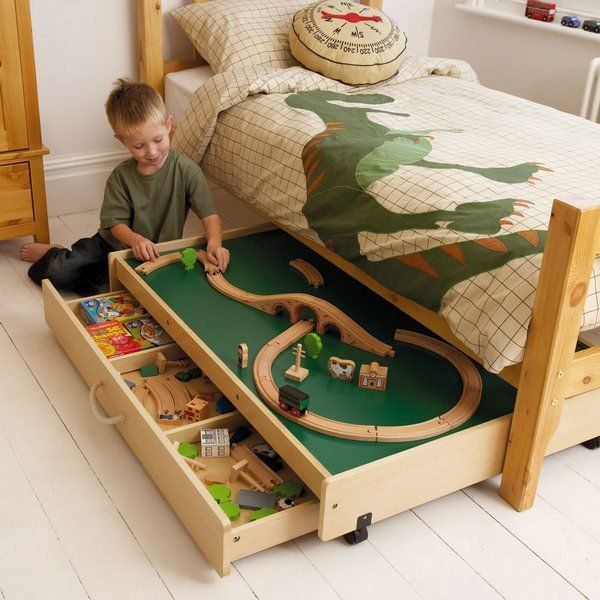 Play Table Under the Bed. This play table under the bed not only provides a useful play area in your busy bedroom, but also reveals more storage space for toys. 