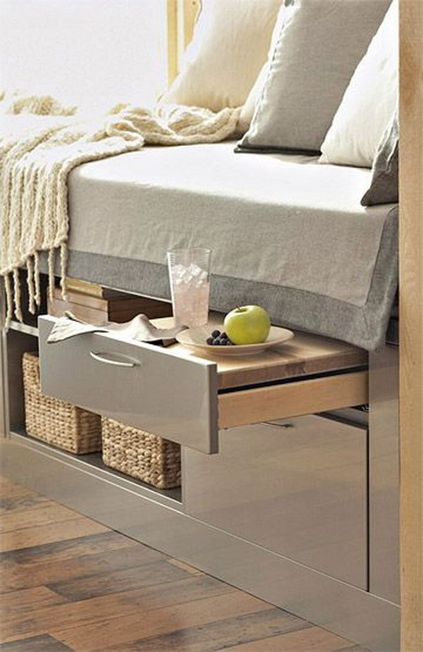 A Bed Incorporates Storage Units and a Pull Out Shelf table. 