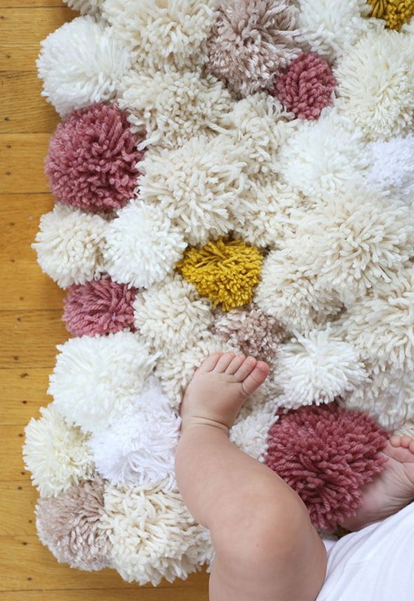 DIY Pom Pom Rug. You can't believe how easy it is to make this cute pom pom rug. 