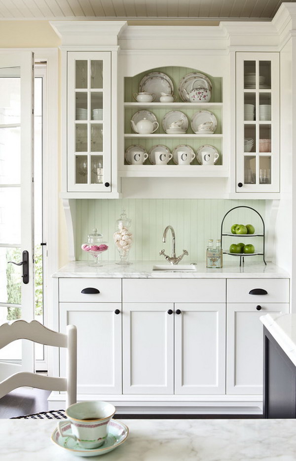 White Kitchen Cabinets Pared with Sage Green Backsplash. 
