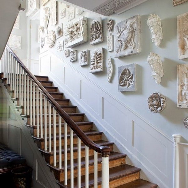 striking sculptures  give this regency inspired hallway timeless appeal. 