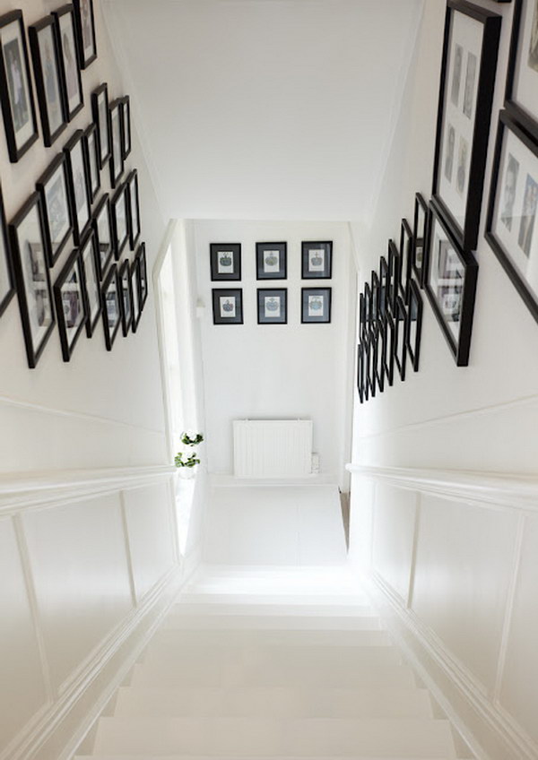 White Staircase With Black Framed Photos. 