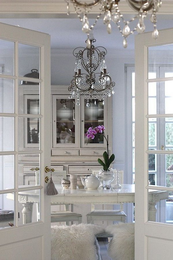 All White Dining Area With French Doors And Crystal Chandelier. 