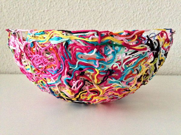 Colorful Yarn Bowl. Never throw away leftover bits and pieces from yarn projects because you can make a piece of art for your home decor. Tutorial via 
