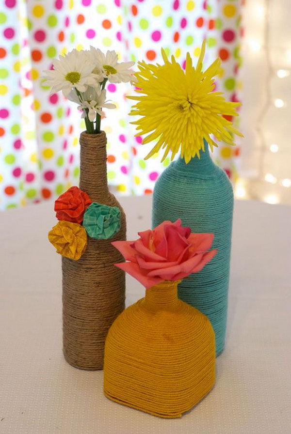 DIY Yarn Wrapped Wine Bottles. Completely easy way to update the look of all those wine bottles and get an expensive look for centerpieces! See the full tutorial on 