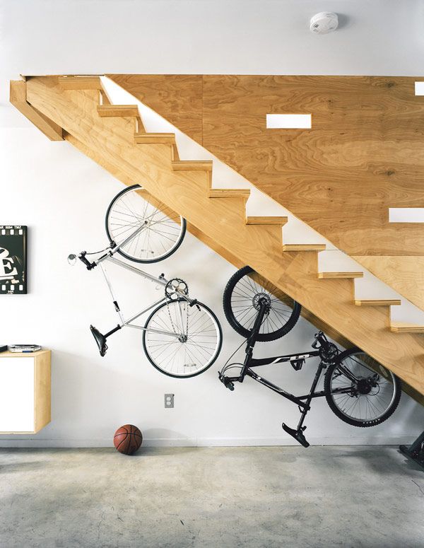 Built in Bicycle Racks in a Staircase. If you are still struggling with where to park the bicycles indoors, you are in the right place. Take advantage of the under stair space with built in racks will help you out. 