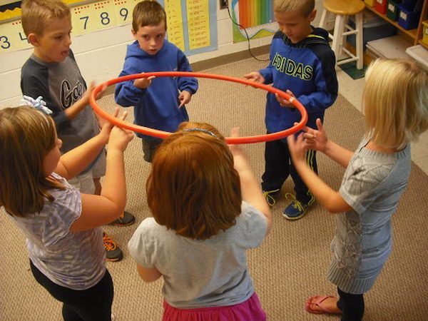 Hula Hoop Team Building Activity. The groups had to move the hula hoop around in a circle until the marker was back where it started with only two fingers each and without dropping it. 