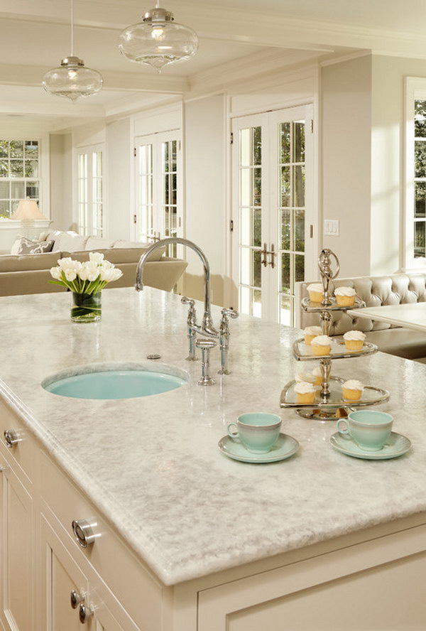 White Princess Quartzite Countertop With White Cabinets And A Pop Of Green. 
