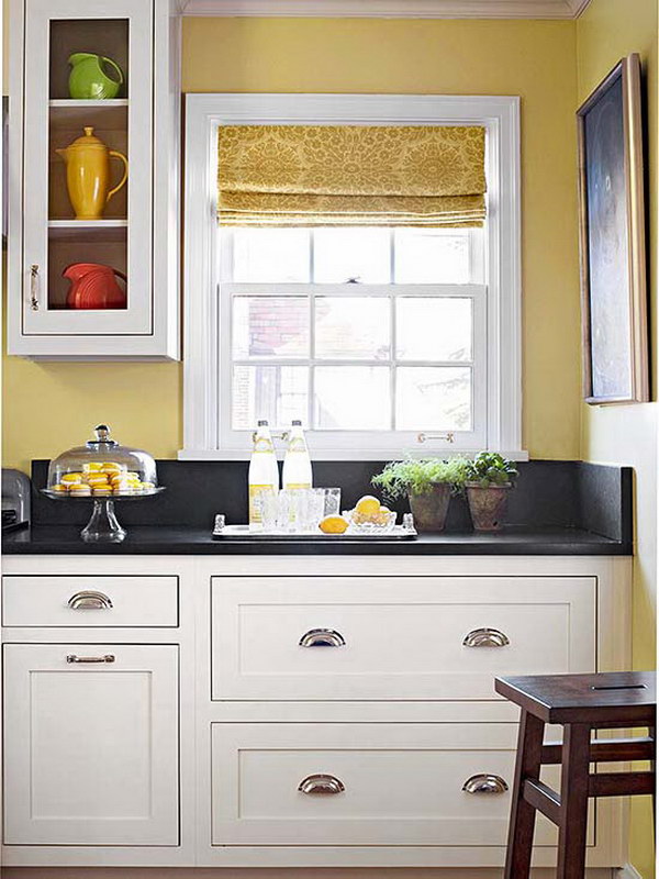Crisp White Cabinets Paired with Dark stone countertops and Warm Yellow Wall Color. 