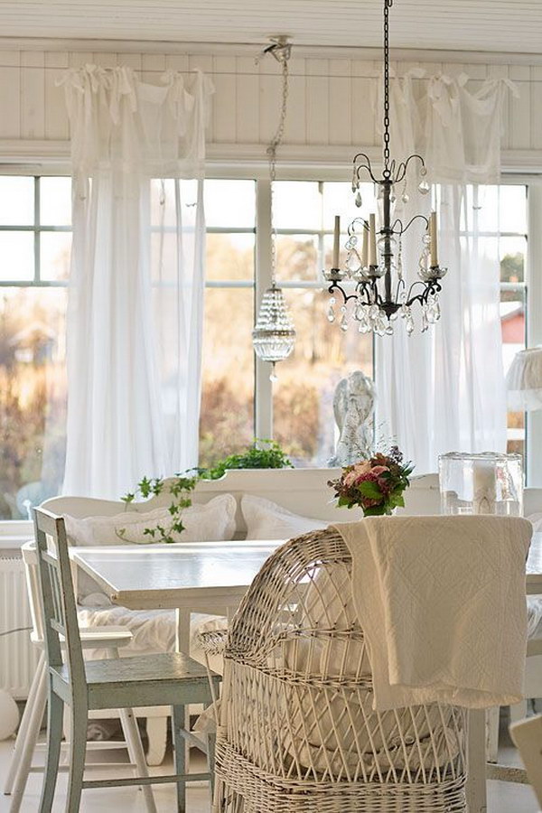 Shabby Chic Dining Room With White Curtains and Beautiful Chandeliers. 